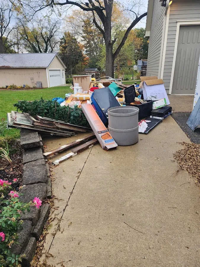 Dumpster being loaded with debris for 10 Yard Dumpster Rental in University Park
